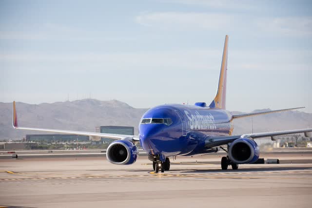 A blue airplane on the runway Description automatically generated with low confidence